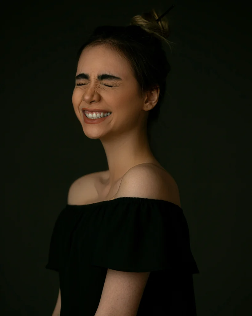 Mujer sonriendo con los ojos cerrados