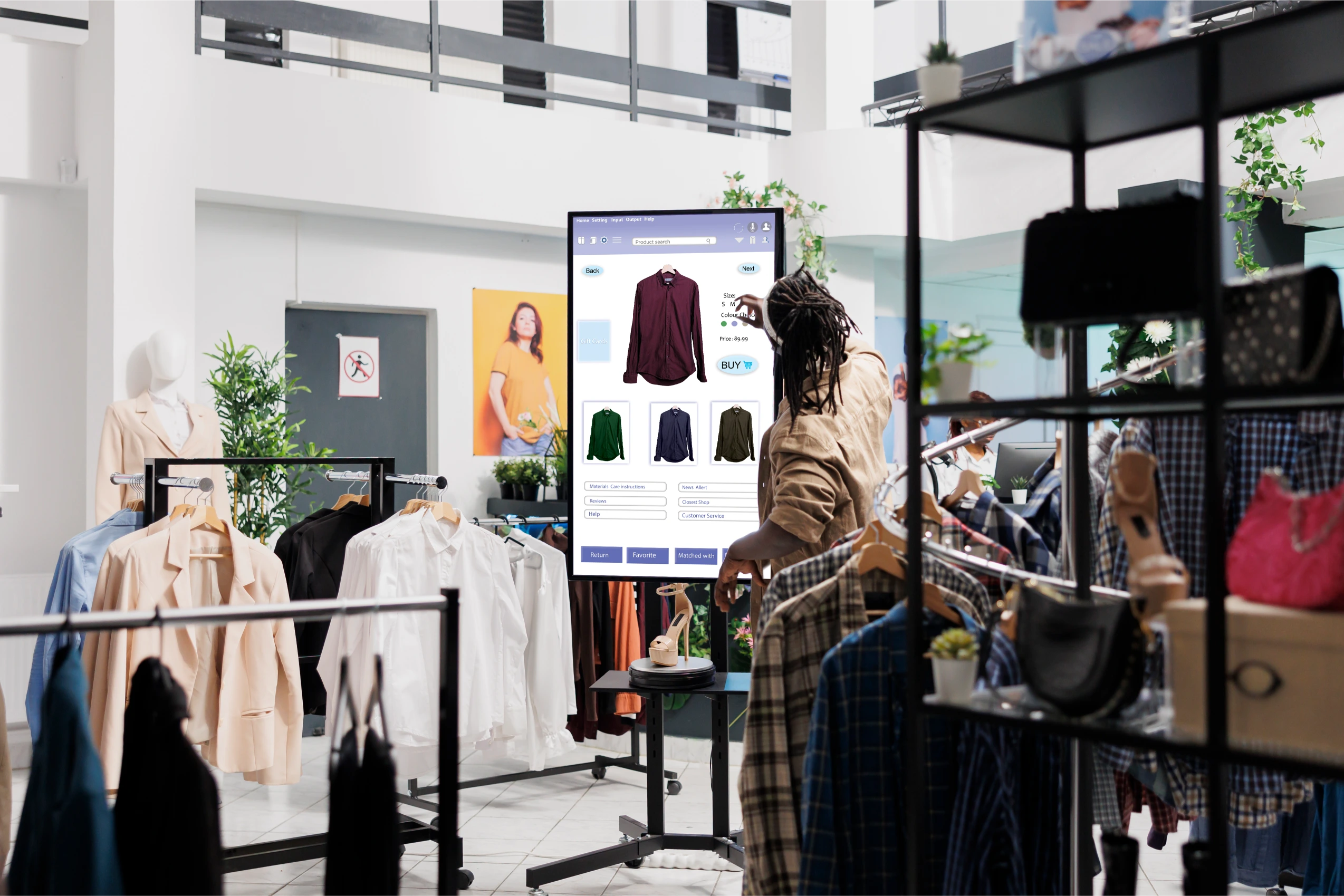 Interior de una tienda de moda con prendas organizadas y una pantalla interactiva, mostrando estrategias de presentación comercial y experiencia de compra.